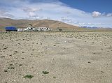 Tibet Kailash 03 Nyalam to Peiku Tso 06 Shishapangma Checkpoint We rested briefly at the Shishapangma Checkpoint. After rounding the ridge to the right, you can drive to Shishapangma North base camp. The village of Siling is visible hugging the ridge just behind the Landcruiser on the right.